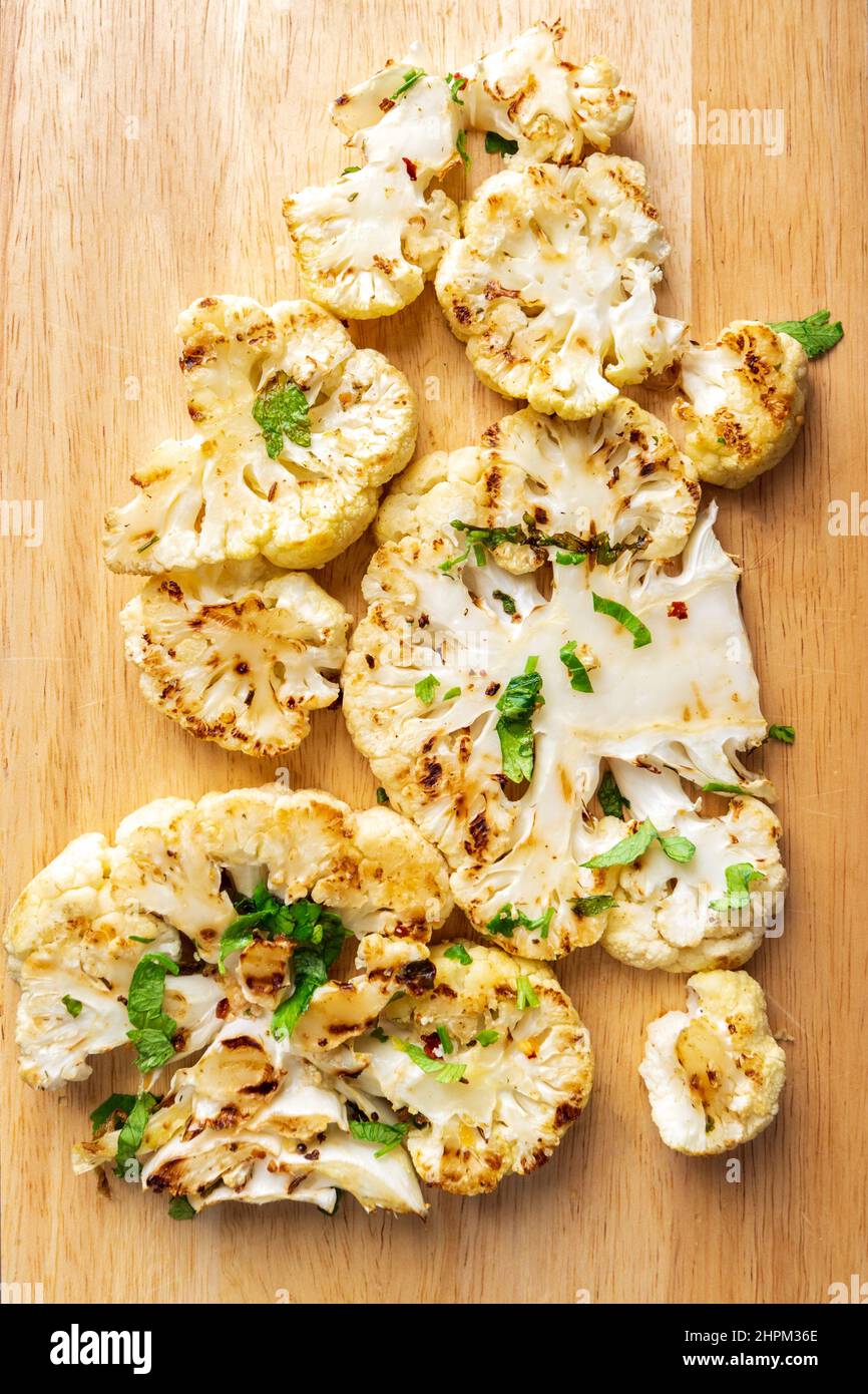 Cauliflower steaks cooking. Healthy eating, plant based meat substitute
