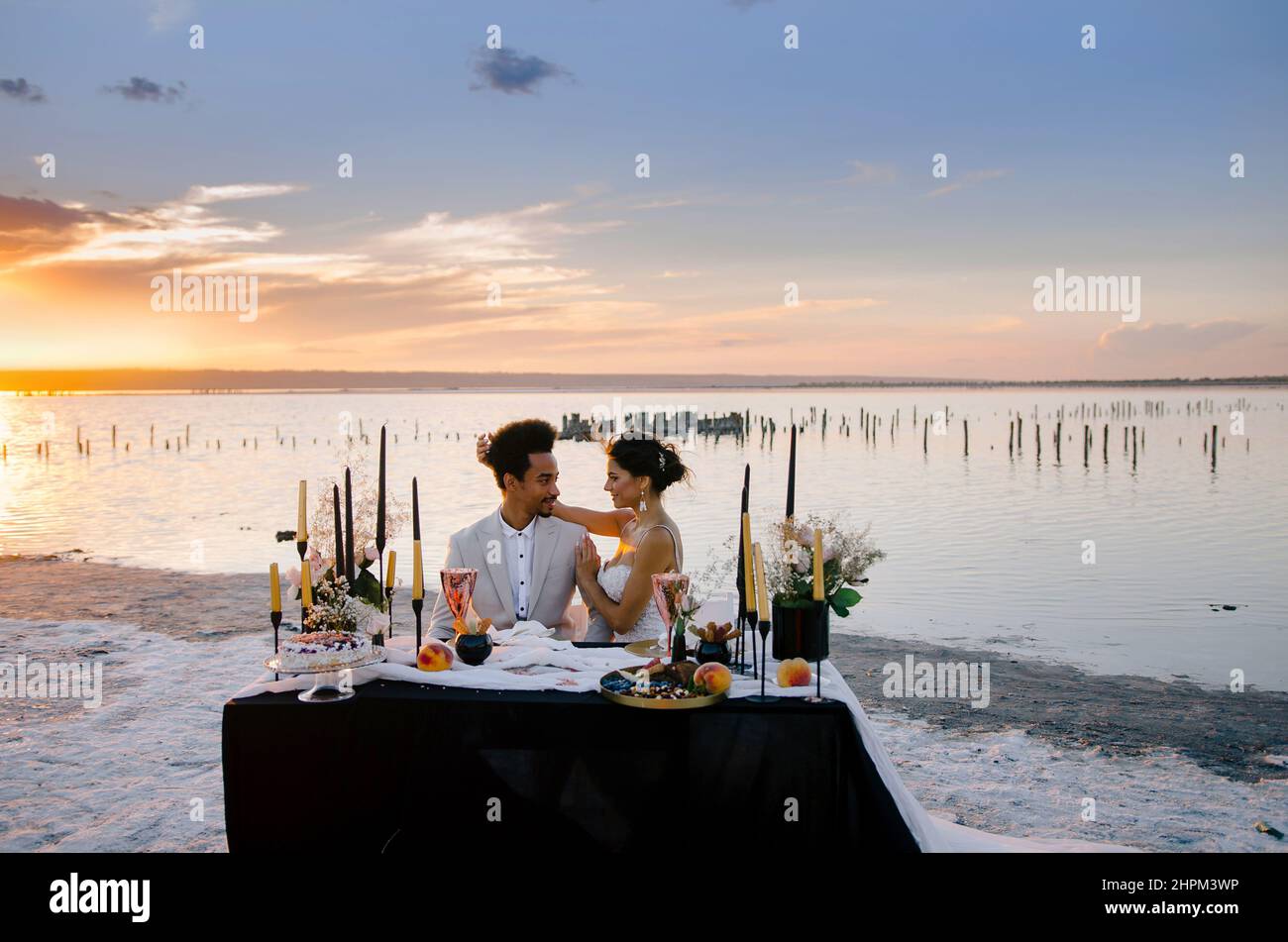 A beautiful romantic couple on an important day for them at sunset outside the city. Concept - love, romance, tenderness. Stock Photo
