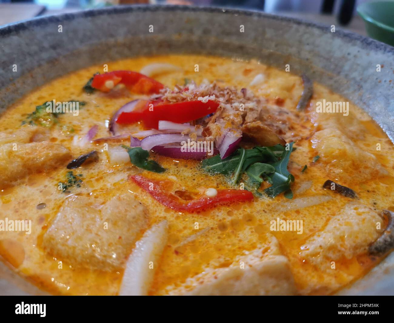 Delicious looking dish of Thai soup with tofu garnished with chillies Stock Photo
