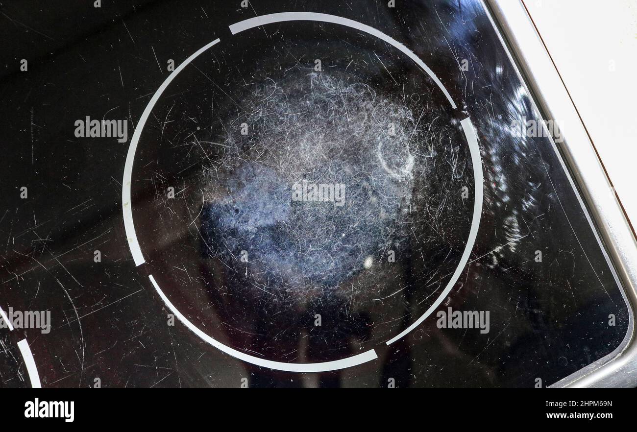 Scratched surface of kitchen glassceramic stove. The concept of caring