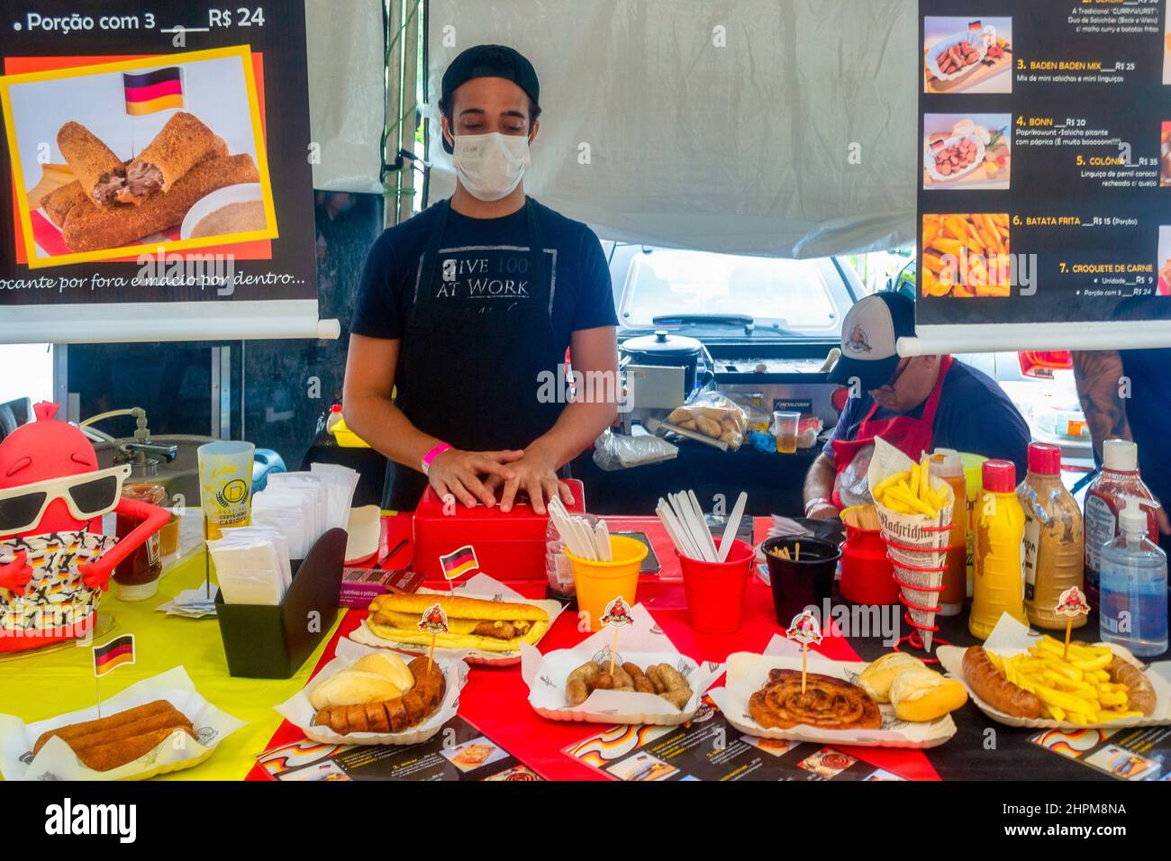 Young man with face mask in the kiosk by Hallo Rio Street Food seen in in the traditional fair in the Cinema Reserva Cultural Niterói. The event showc Stock Photo