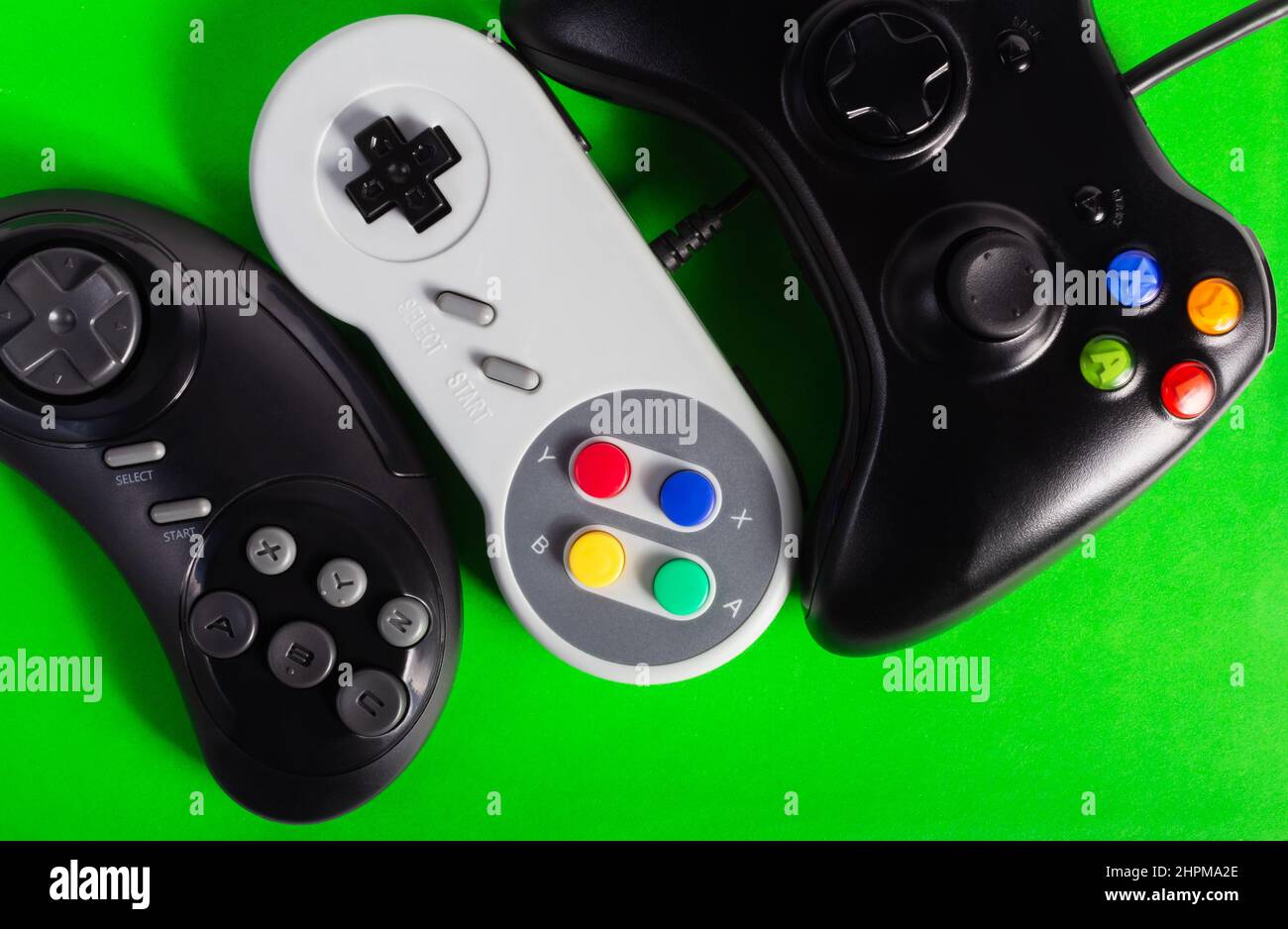 Photo of classic 8 bit, 16 bit and modern game pad controllers laying ...