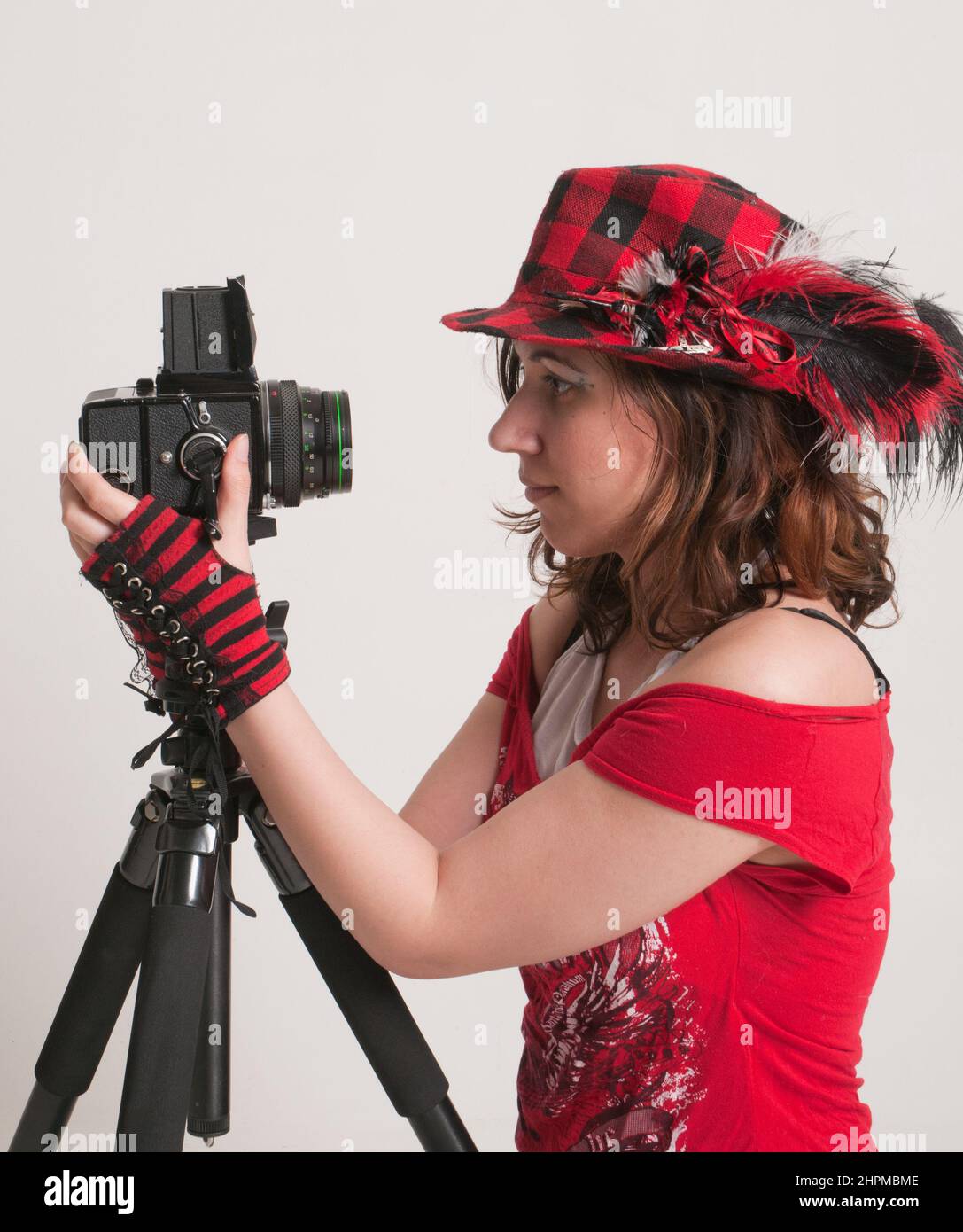Young Woman posing with a medium format film camera Stock Photo