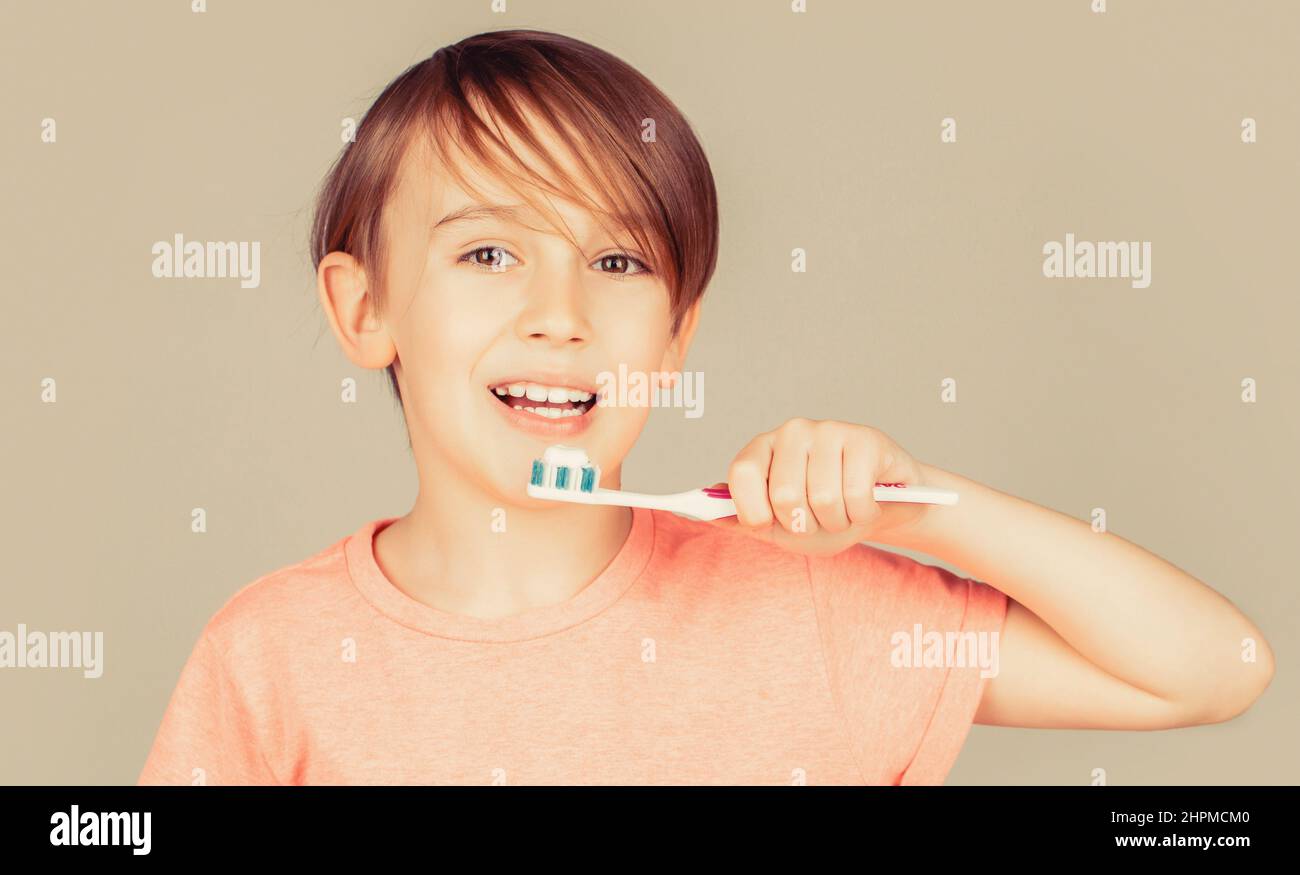 Joyful child shows toothbrushes. Little boy cleaning teeth. Dental hygiene. Happy little kid brushing her teeth. Kid boy brushing teeth. Boy Stock Photo