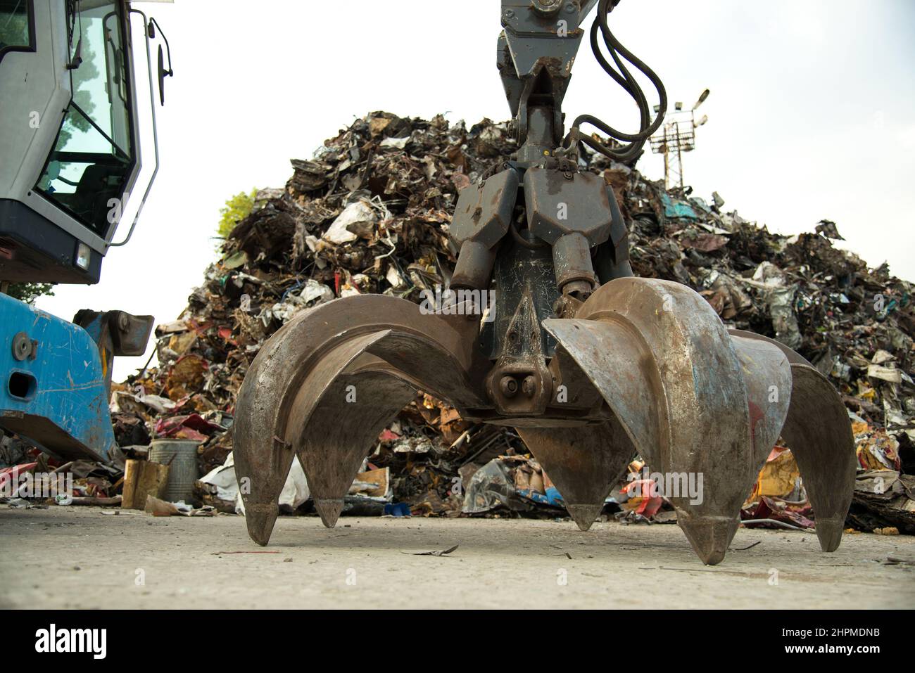 Large tracked excavator working a steel pile at a metal recycle yard