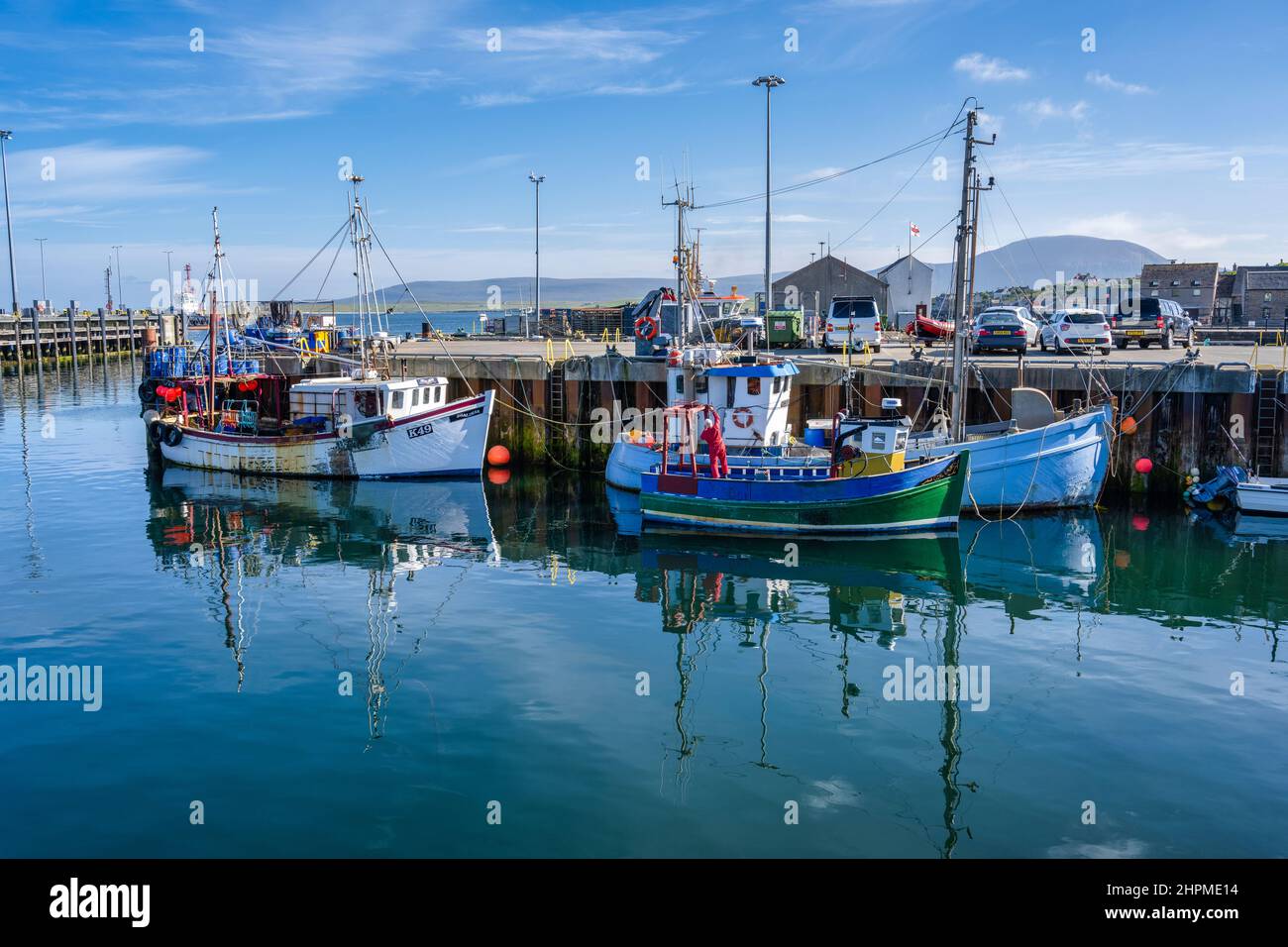 Fishing boats tied up on quayside at Stromness harbour – Stromness, Mainland Orkney, Scotland, UK Stock Photo