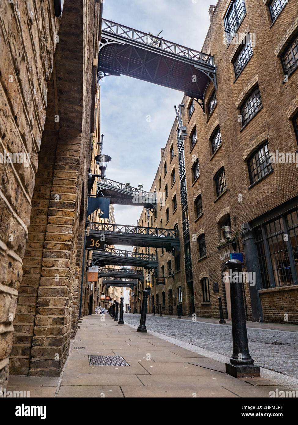 Shad Thames, London. Low, wide angle view of the Victorian architecture of the former industrial area now a gentrified shopping and business district. Stock Photo