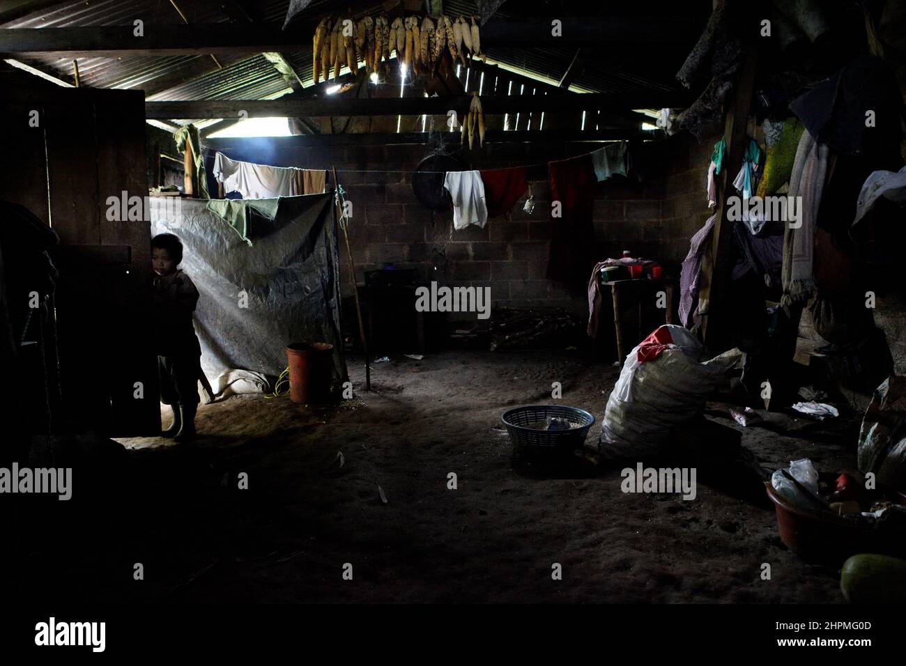 Older son in the hut of Zoila Cajal, 32, mother of 5 months old twins in the village Yuhilxa Guatemala. Stock Photo