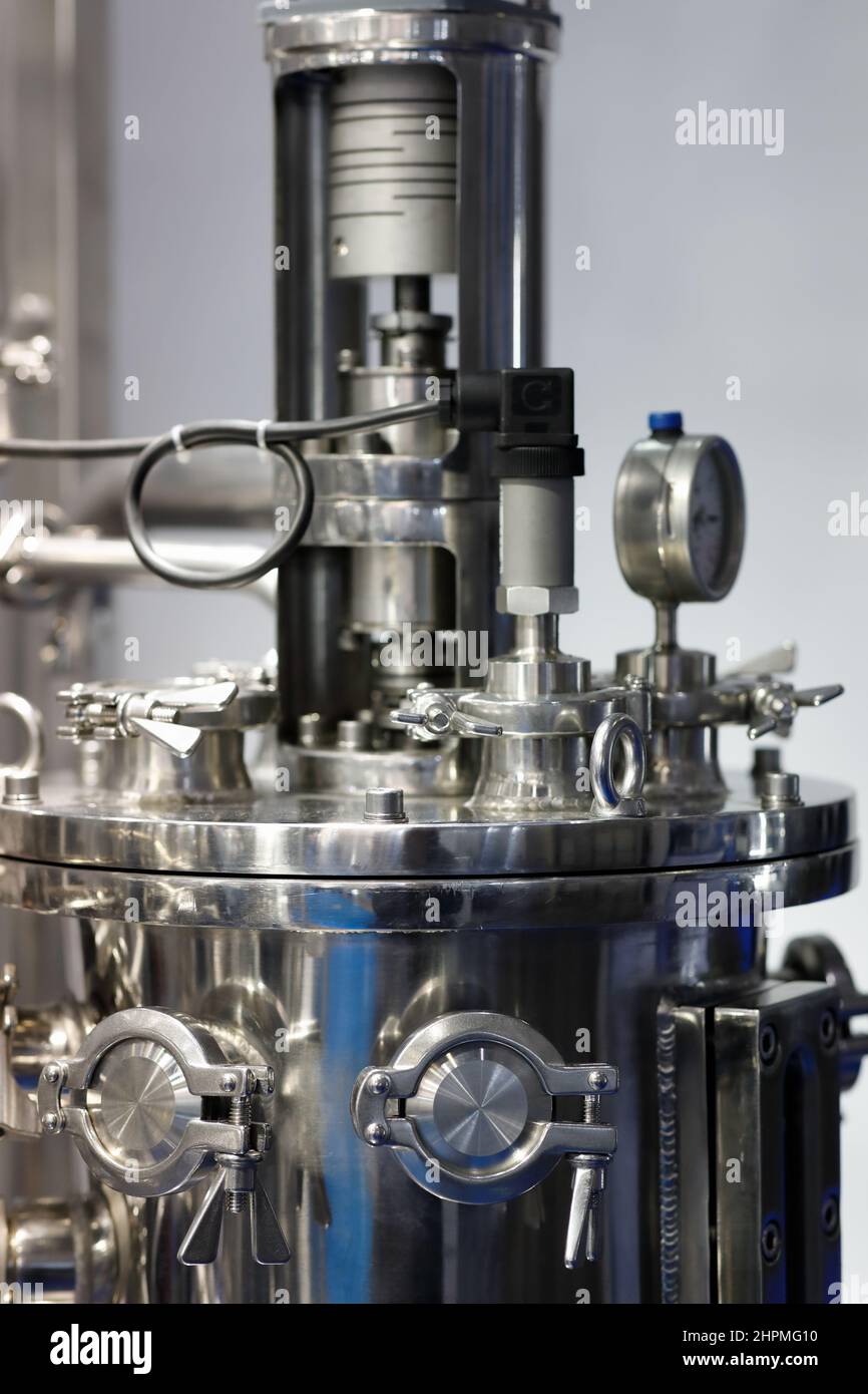 Automatic stainless steel pharmaceutical fermenter. Aseptic pharma fermenter. Cell culture bioreactor. Selective focus. Stock Photo