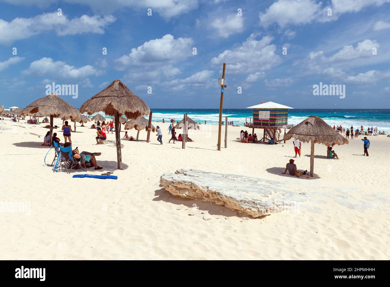 Tourists sunbathing on Delphin Beach of Cancun on a sunny day by the Caribbean Sea, Yucatan Peninsula, Mexico. Stock Photo
