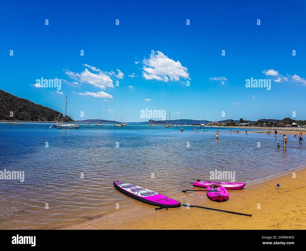 Stand up paddle board and Kayak ashore on busy Ettalong beach, Central Coast, NSW, Australia Stock Photo