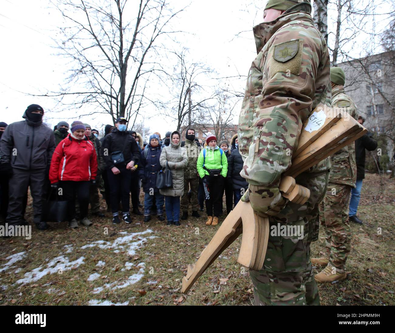 KHARKIV, UKRAINE - FEBRUARY 19, 2022 - A man in a camouflage uniform holds cardboard rifle cutouts during the territorial defence drill for civilians Stock Photo