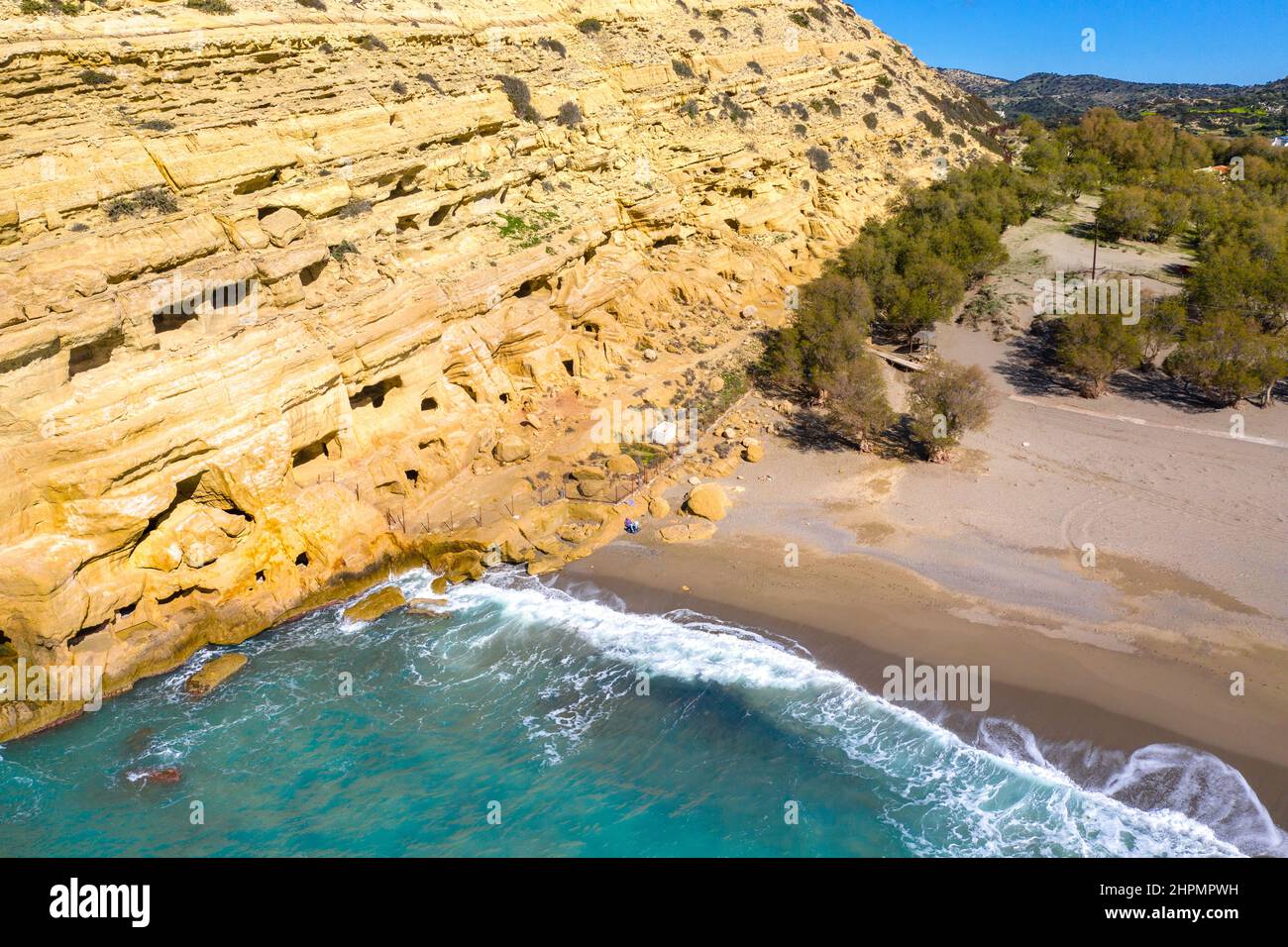 Matala beach with caves on the rocks that were used as a roman cemetery and at the decade of 70's were living hippies, Crete,  Greece Stock Photo