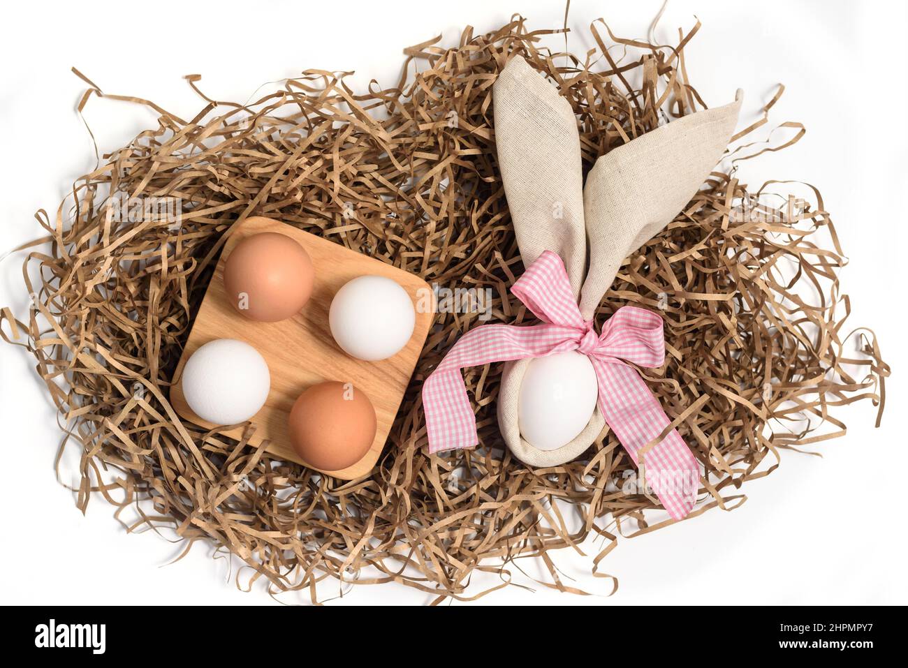Easter natural eggs in a wooden bowl and rabbit ears from a linen napkin Stock Photo