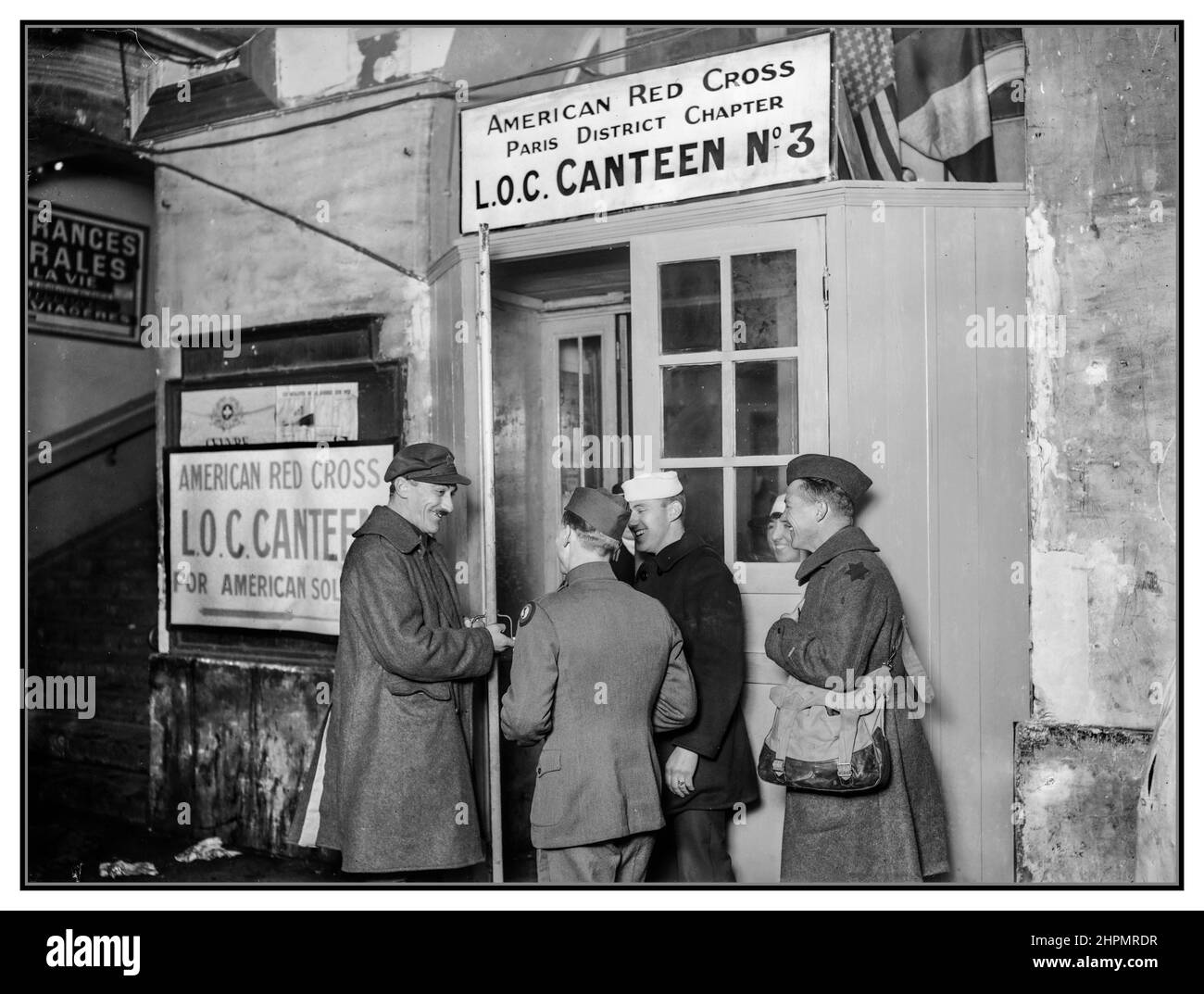 WW1 RED CROSS Paris 1915 Entrance to the American Red Cross Canteen at Gare St. Lazare, Paris, France. This is the largest and best equipped canteen in the city, handling thousands of Americans day and night. Sailors are now a welcome sight in Paris and they seem to like the Red Cross canteen service. Here is a jelly quartette about to go in for lunch  (Hine, Lewis Wickes, 1874-1940, photographer) World War 1 Paris France Stock Photo