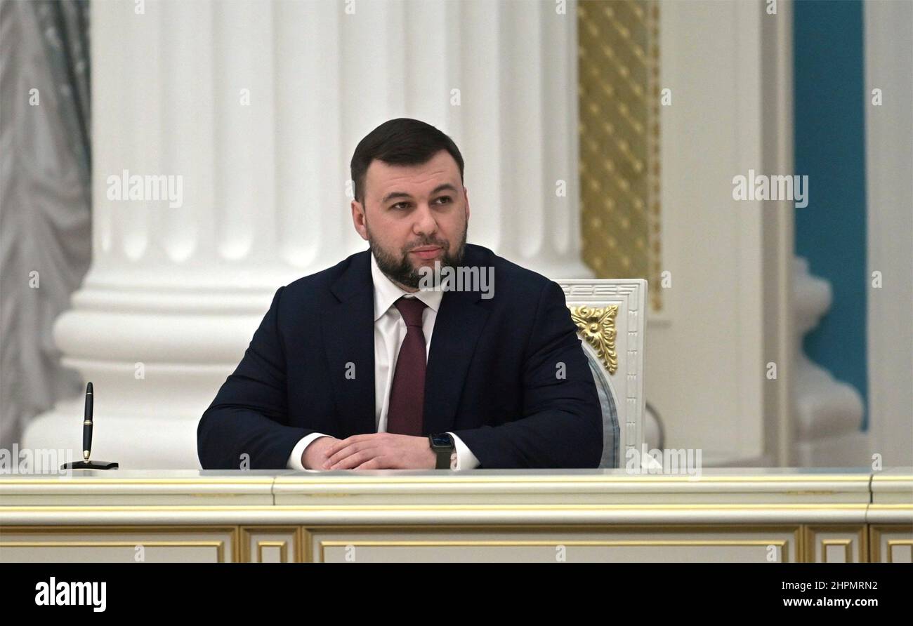 Moscow, Russia. 22nd Feb, 2022. The leader of the separatist Donetsk People's Republic Denis Pushilin, watches as Russian President Vladimir Putin signs an executive order recognizing the Ukrainian regions of Donetsk and Lugansk during a ceremony at the Kremlin, February 21, 2022 in Moscow, Russia. Credit: Alexei Nikolsky/Kremlin Pool/Alamy Live News Stock Photo