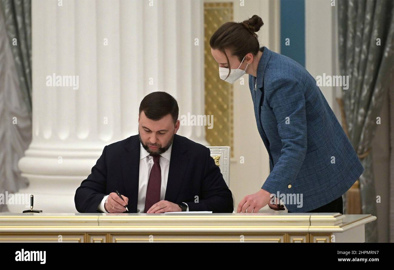 Moscow, Russia. 21st Feb, 2022. The leader of the separatist Donetsk People's Republic Denis Pushilin, signs a Friendship Agreement with Russian President Vladimir Putin, recognizing the Ukrainian regions of Donetsk and Lugansk during a ceremony at the Kremlin, February 21, 2022 in Moscow, Russia. Credit: Alexei Nikolsky/Kremlin Pool/Alamy Live News Stock Photo