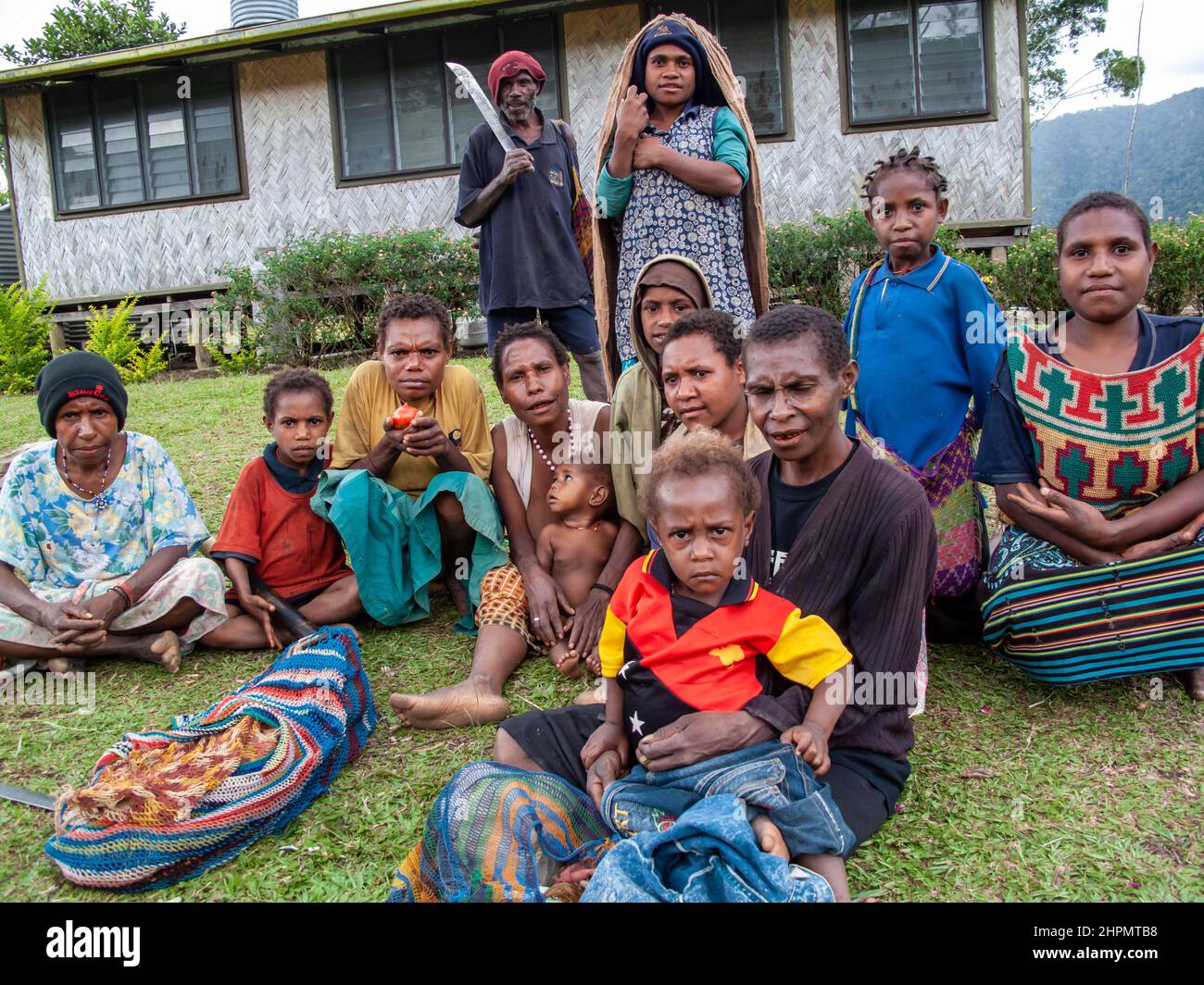 Group of people gathering outside the local health clinic in Eastern Highlands Province of PNG. Stock Photo