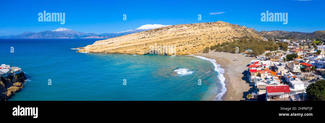Matala beach with caves on the rocks that were used as a roman cemetery and at the decade of 70's were living hippies, Crete,  Greece Stock Photo
