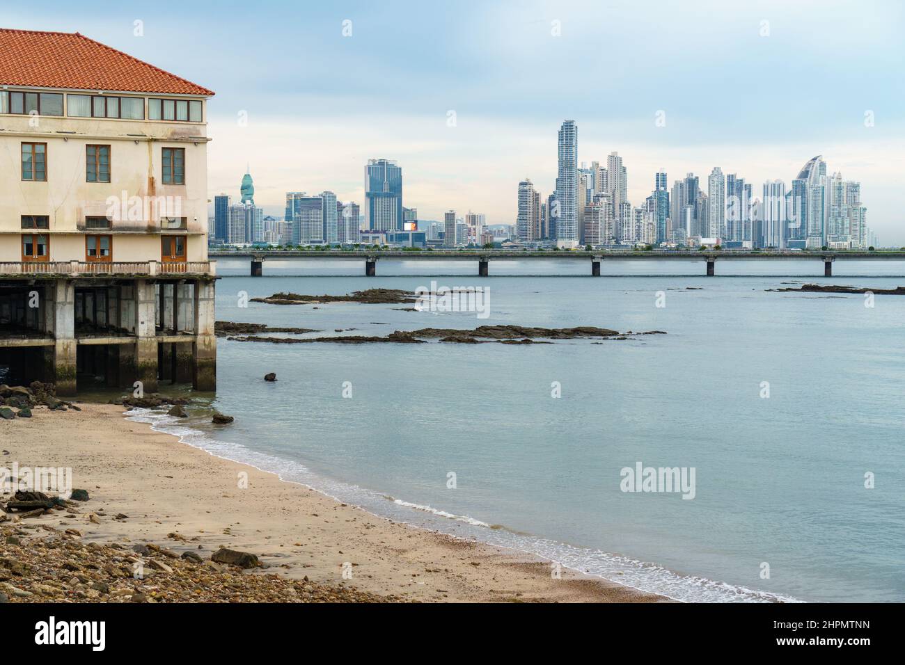 Modern skyline viewed from the beach in Casco Viejo Panama City, with a bridge separating new from old. Stock Photo