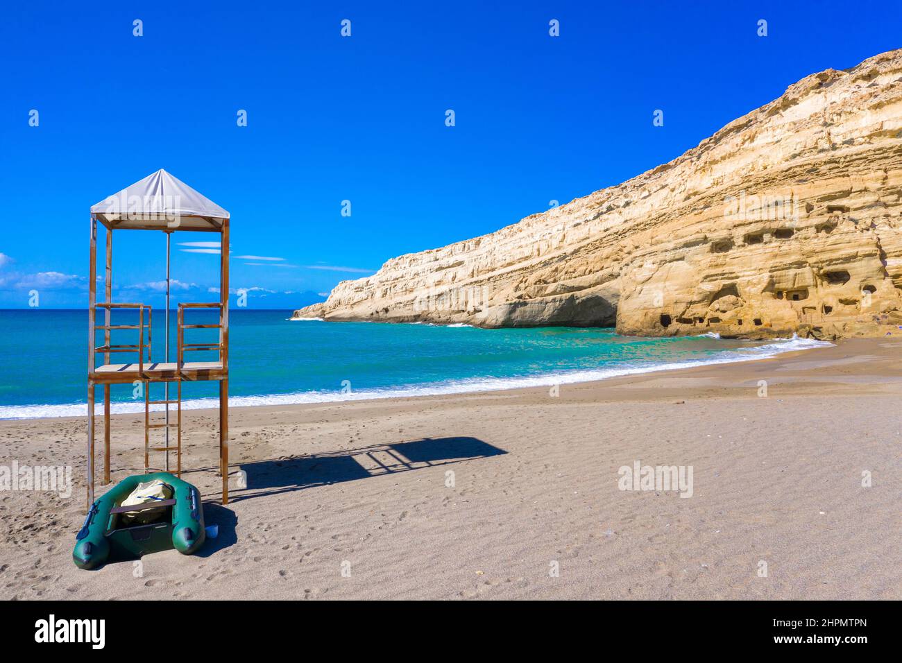 Matala beach with caves on the rocks that were used as a roman cemetery and at the decade of 70's were living hippies, Crete,  Greece Stock Photo