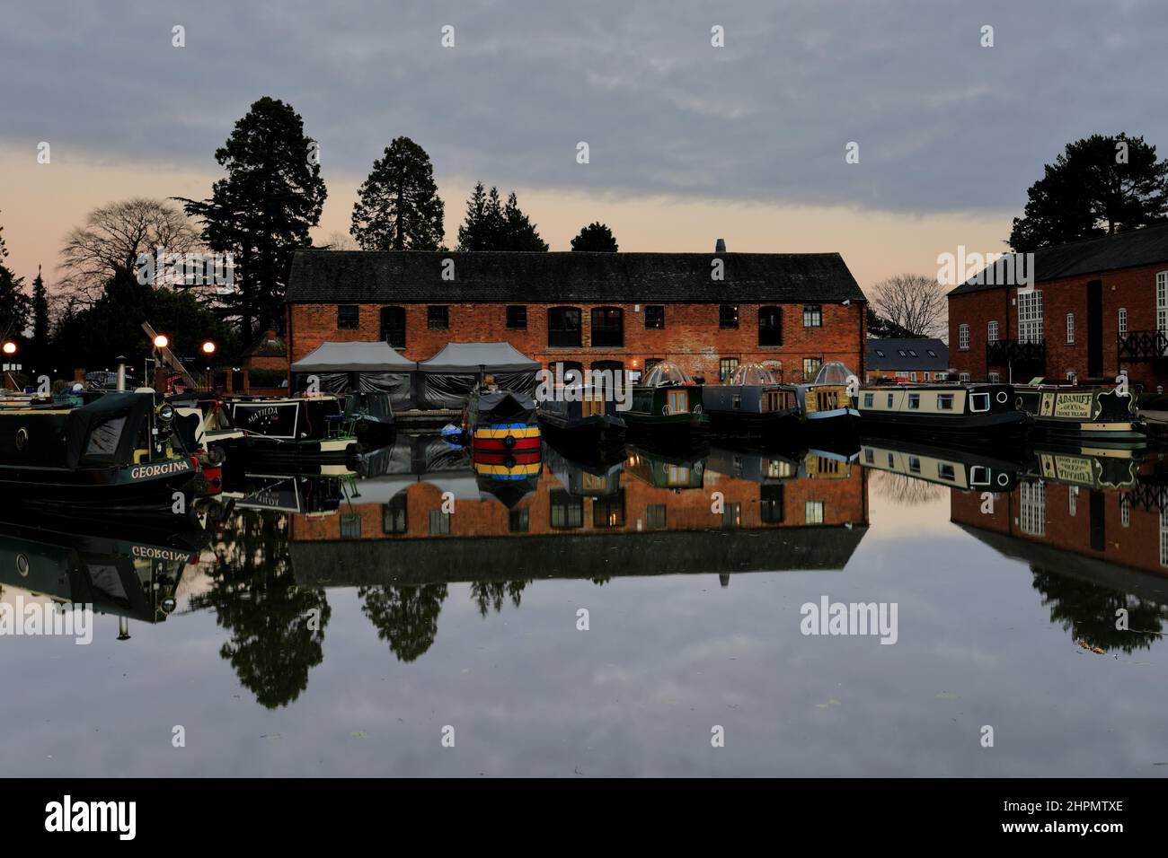 Dusk, Narrowboats at the Grand Union Canal Basin, Market Harborough town, Leicestershire, England; UK Stock Photo
