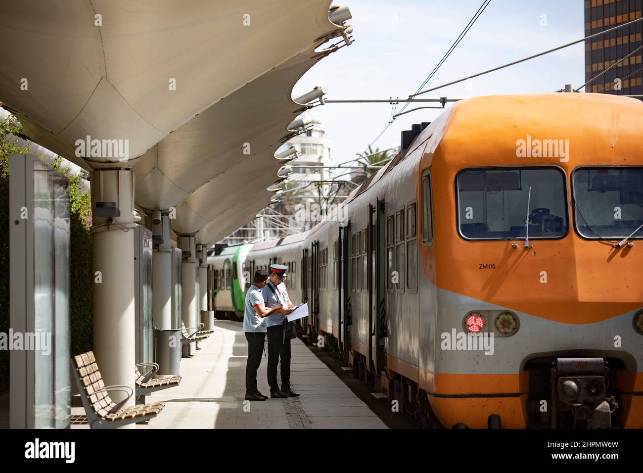 Conductors wait outside a passenger train on the boarding platform at Casa Port train station in Casablanca, Morocco. Stock Photo