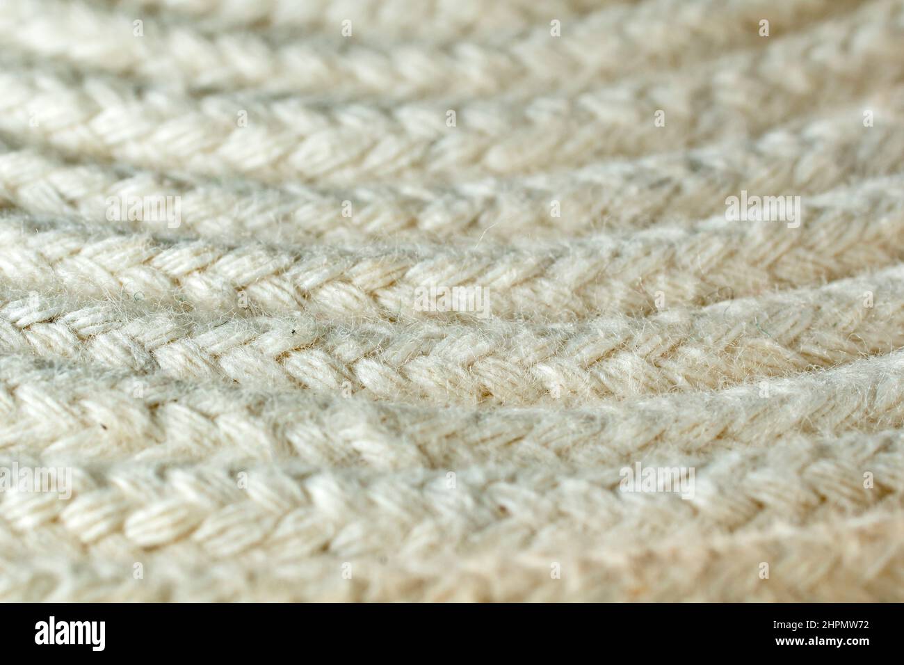 Close up detail of the pattern produced by coiling a thin white braided cotton rope. Stock Photo