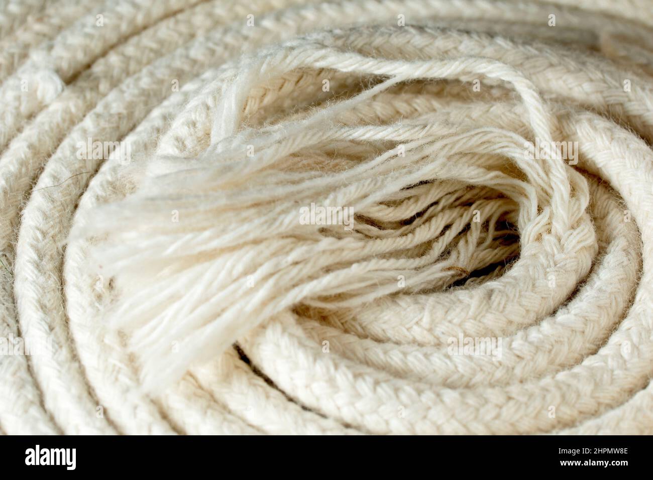 Close up of the frayed end of a thin white cotton rope commonly used in the UK for hanging clothes outside to dry. Stock Photo