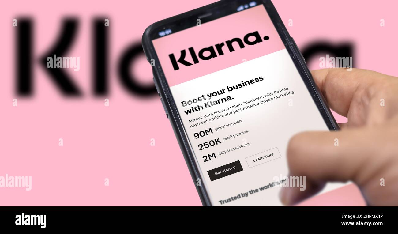 Rome, Italy, February 2022: Hand holding a device with the Klarna mobile app on the screen. Klarna is the largest private fin-tech start-up in Europe, Stock Photo