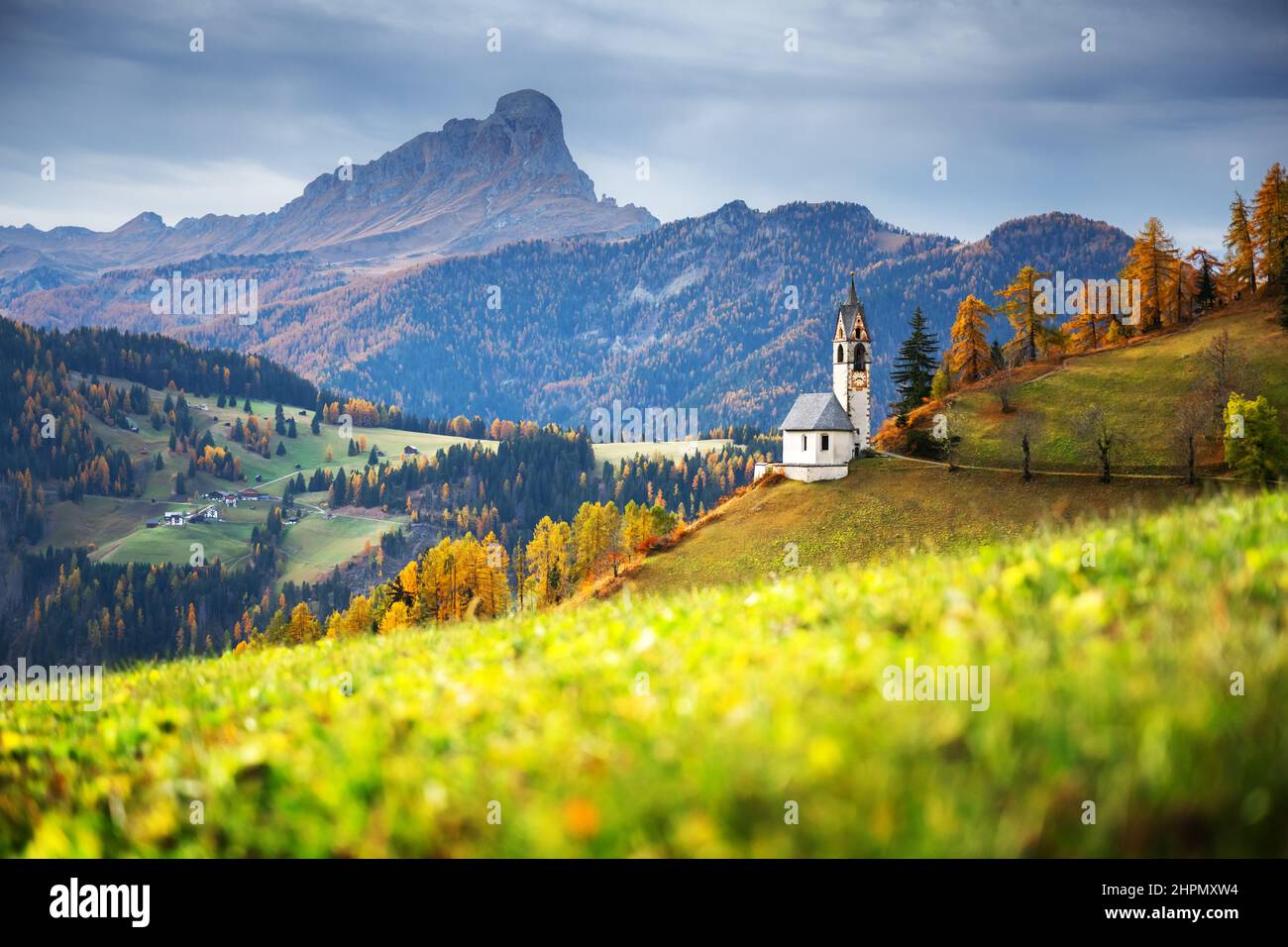 Santa Barbara church at the autumn Dolomite Alps. Amazing landscape with small chapel on sunny meadow at San Genesio village location, Province of Bolzano, South Tyrol, Italy Stock Photo