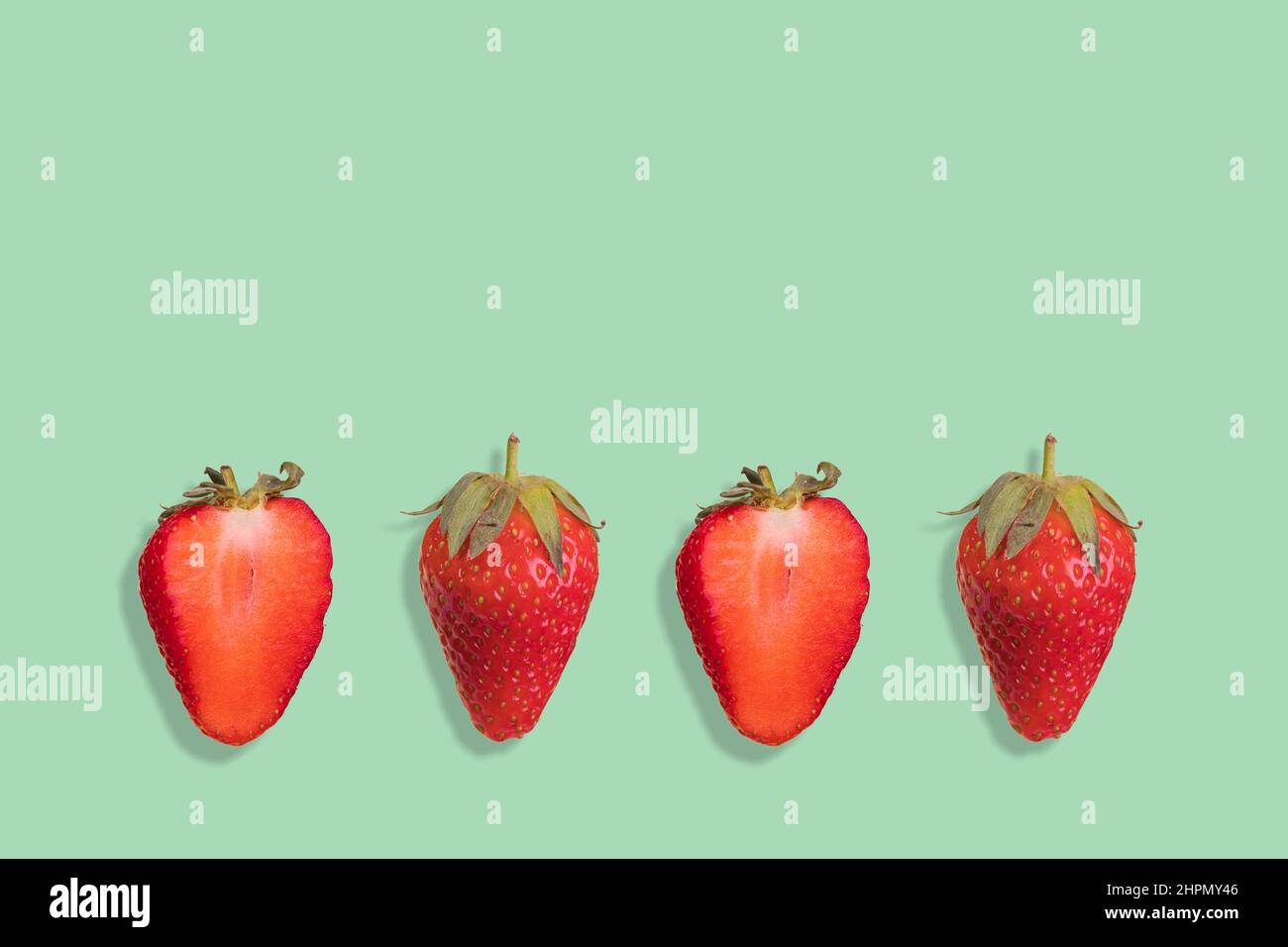 Strawberry pattern on a pastel green background, creative flat lay healthy food concept, top view. Stock Photo