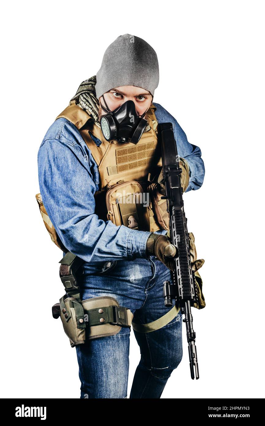 Isolated photo of urban soldier in tactical military outfit and gas mask standing with rifle and gas mask background Stock Photo - Alamy