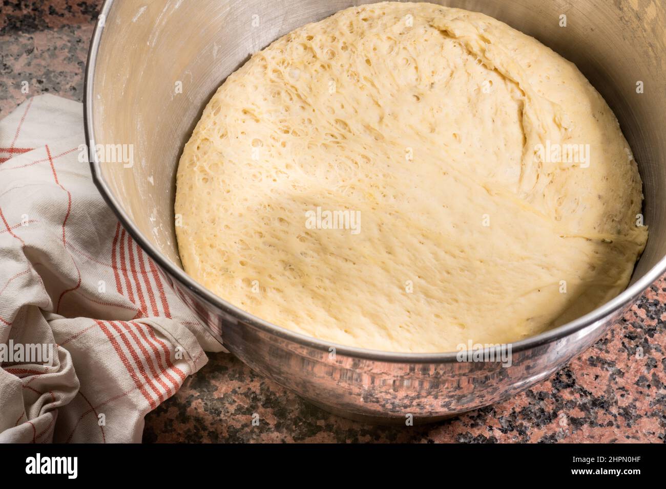 Yeast dough, knead, prepare, kitchen, stir, bowl, dough lifter, flour, yeast, water, salt. Bake, cooking, modern, the dough goes Stock Photo