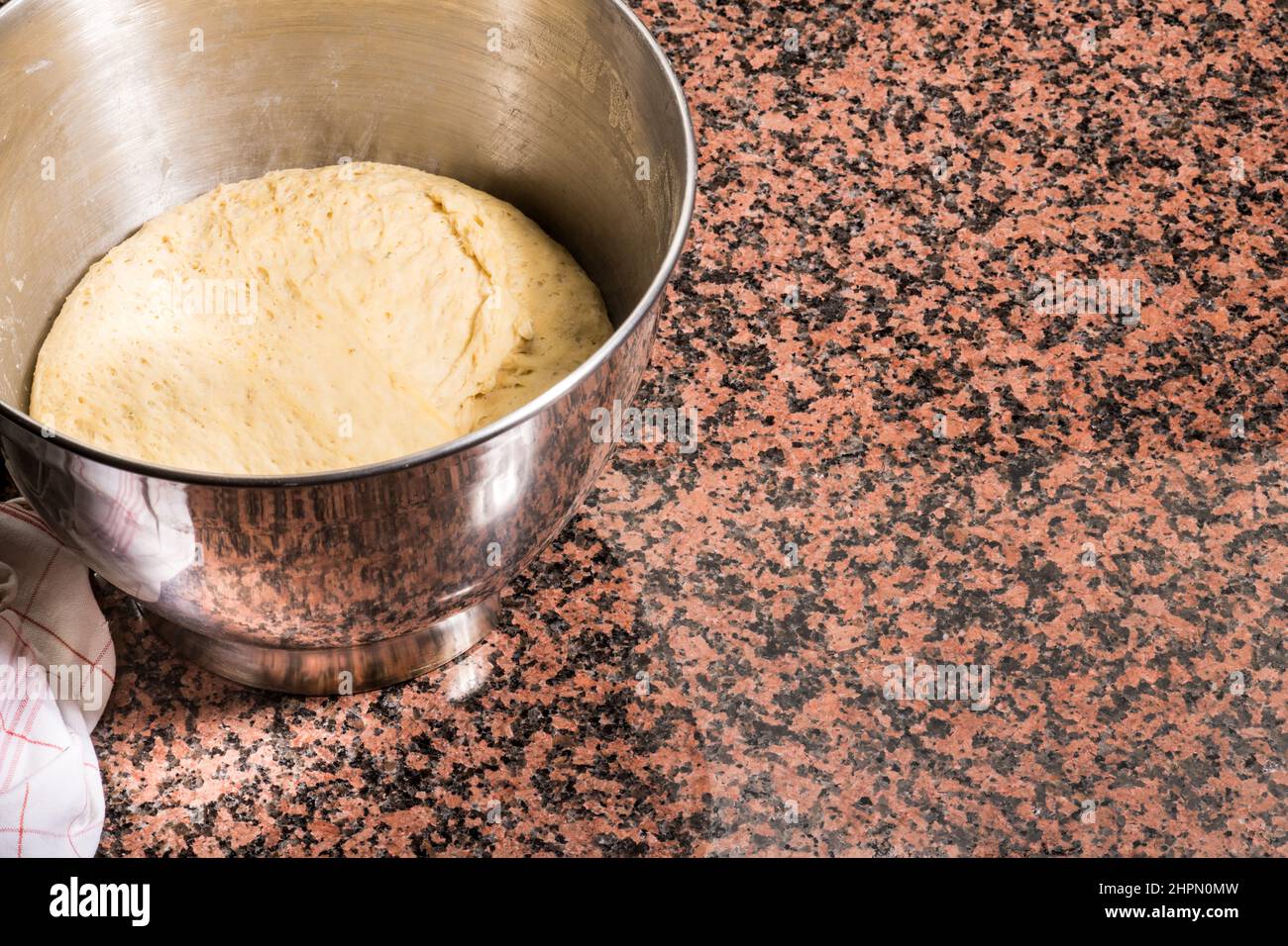 Yeast dough, knead, prepare, kitchen, stir, bowl, dough lifter, flour, yeast, water, salt. Bake, cooking, modern, the dough goes Stock Photo