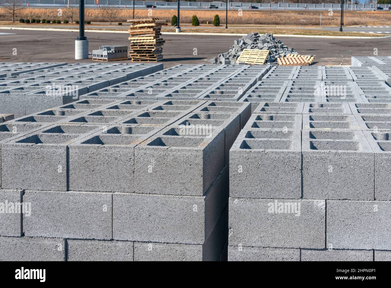 Horizontal shot of cinder blocks with a pile of broken ones in the background. Stock Photo