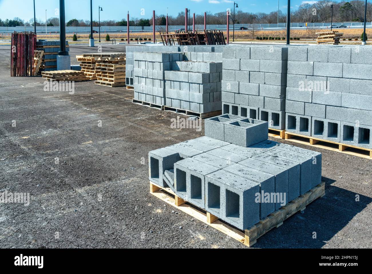 Horizontal shot of pallets of new cinder blocks at an industrial construction site. Stock Photo