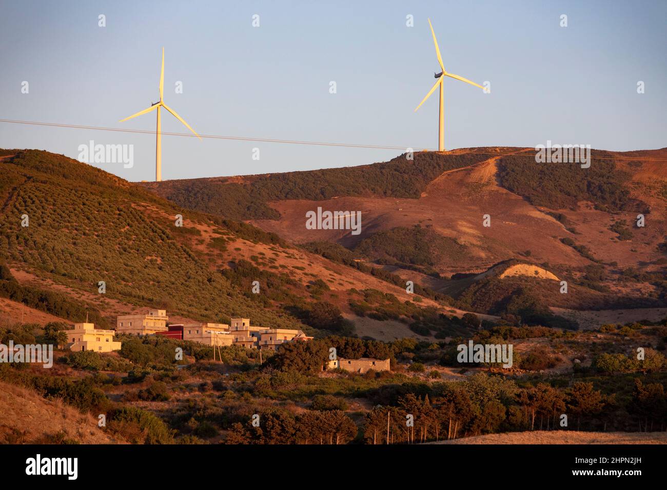 Wind turbines generate electricity on a hillside outside of Tanger Med Port in Ksar es Seghir, northern Morocco, North Africa. Stock Photo