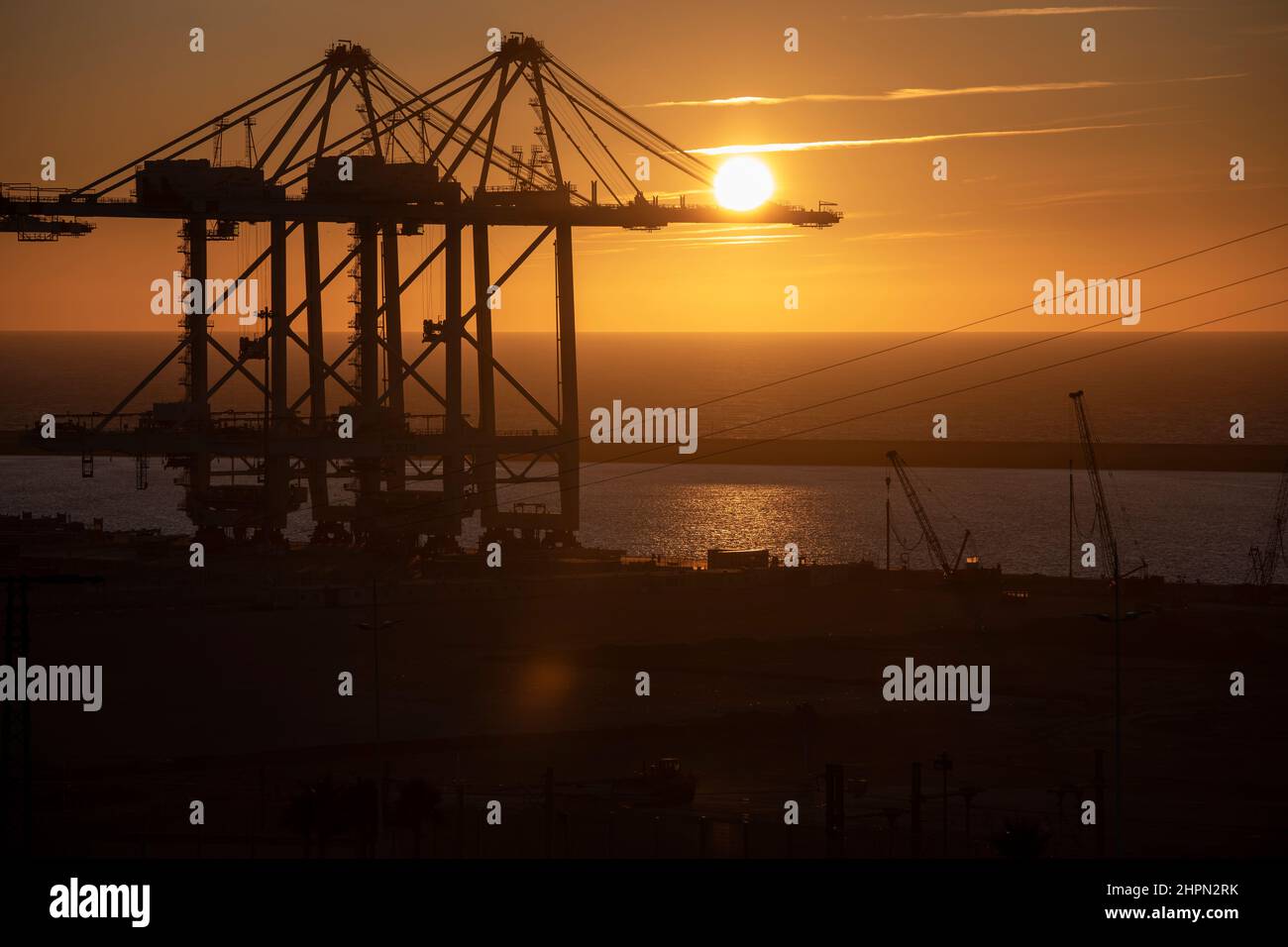 Ship-to-shore container cranes stand ready to handle port cargo at Tanger Med Port in Ksar es Seghir, Morocco, North Africa. Stock Photo