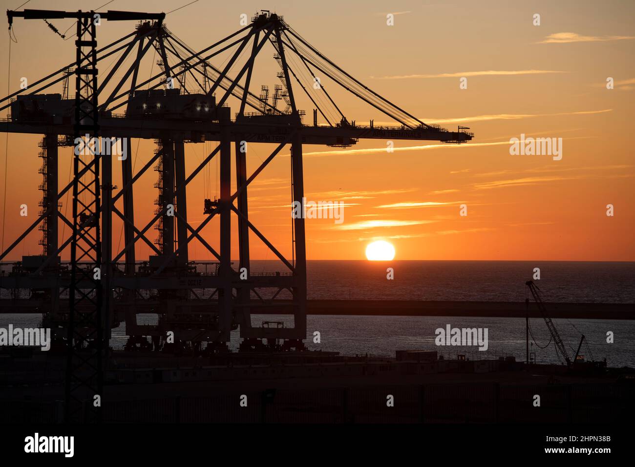 Ship-to-shore container cranes stand ready to handle port cargo at Tanger Med Port in Ksar es Seghir, Morocco, North Africa. Stock Photo