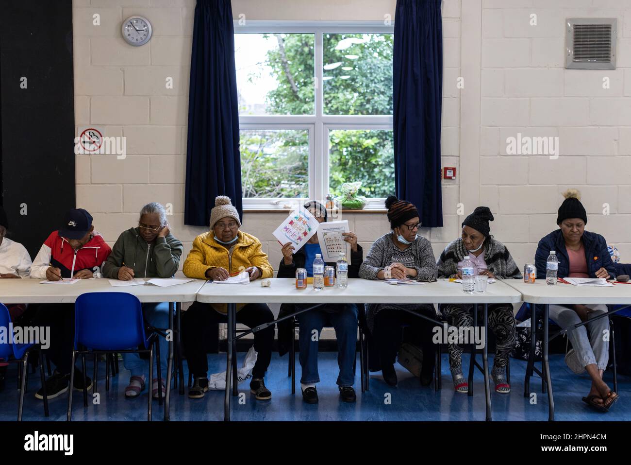 Exiles from Chagos Islands inside Broadfield Community Centre, together they gather in the community hall in Sussex to reminisce about home. Stock Photo