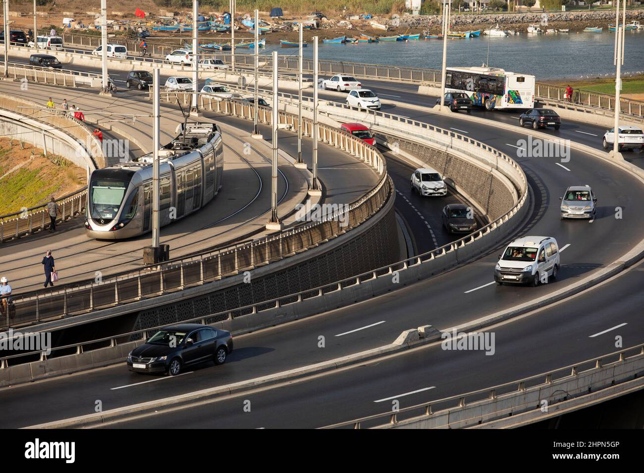 Busy vehicle traffic and passenger train moves across the Hassan II bridge connecting Salé and Rabat in Morocco, North Africa. Stock Photo