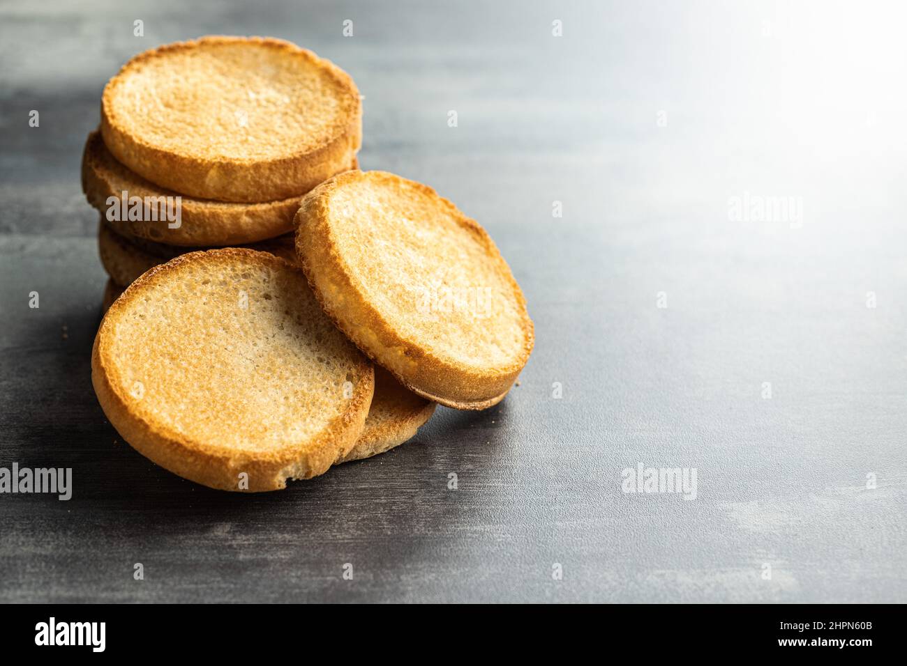 Dietary rusks bread. Crusty biscuits on kitchen table. Stock Photo