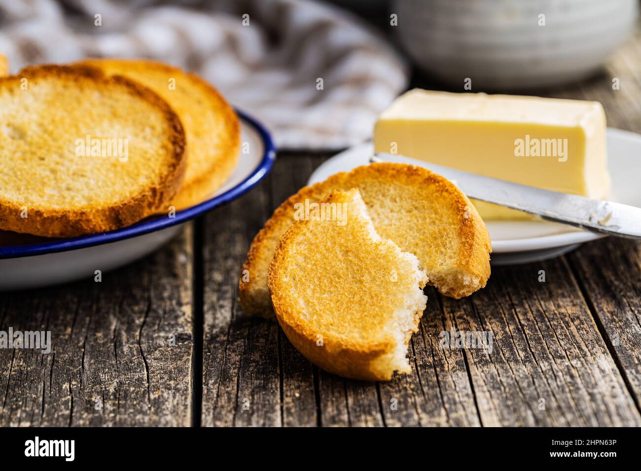Dietary rusks bread. Crusty biscuits on wooden table. Stock Photo