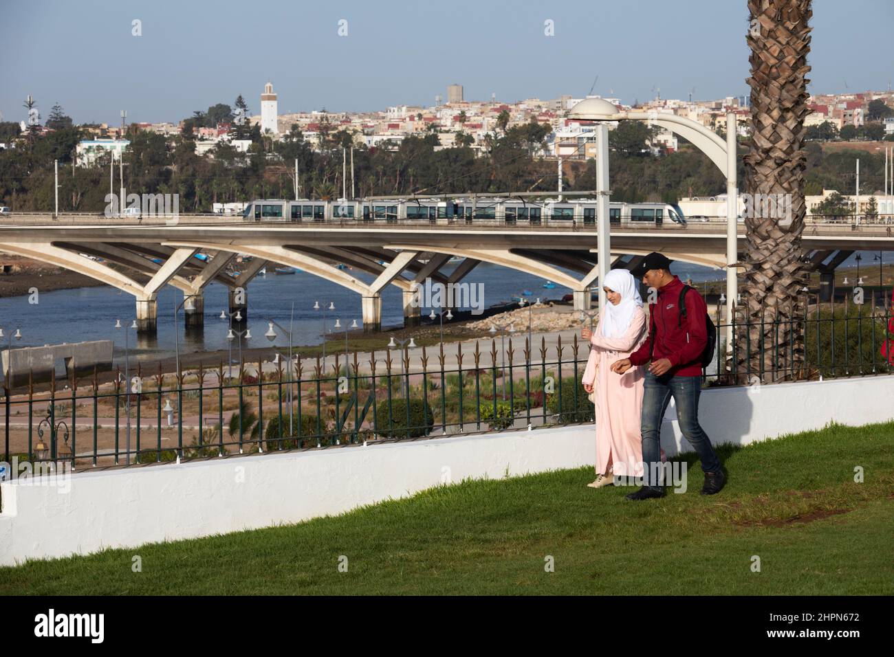 Busy vehicle traffic and passenger train moves across the Hassan II bridge connecting Salé and Rabat in Morocco, North Africa. Stock Photo