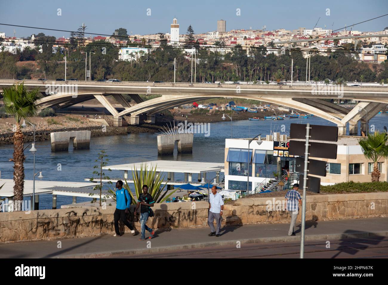 Busy vehicle traffic and passenger train moves across the Hassan II bridge connecting Salé and Rabat in Morocco, North Africa. Stock Photo