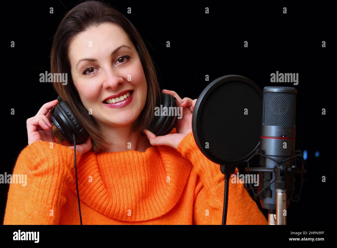 Woman With Headphones And Studio Microphone ; Close up female vocalist
