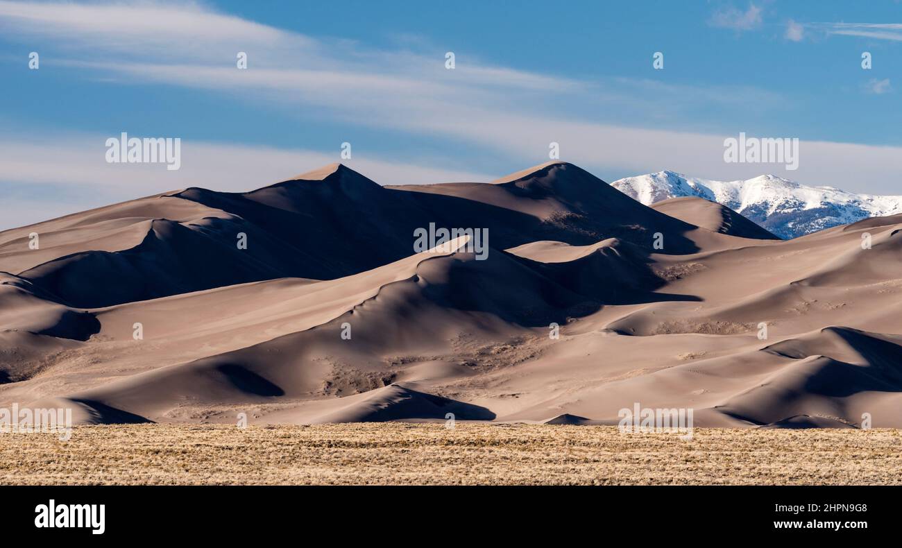 Grasslands, Dune Field and High Mountain Peaks are part of The Great Sand Dunes National Park and Preserve in South Central Colorado. Stock Photo