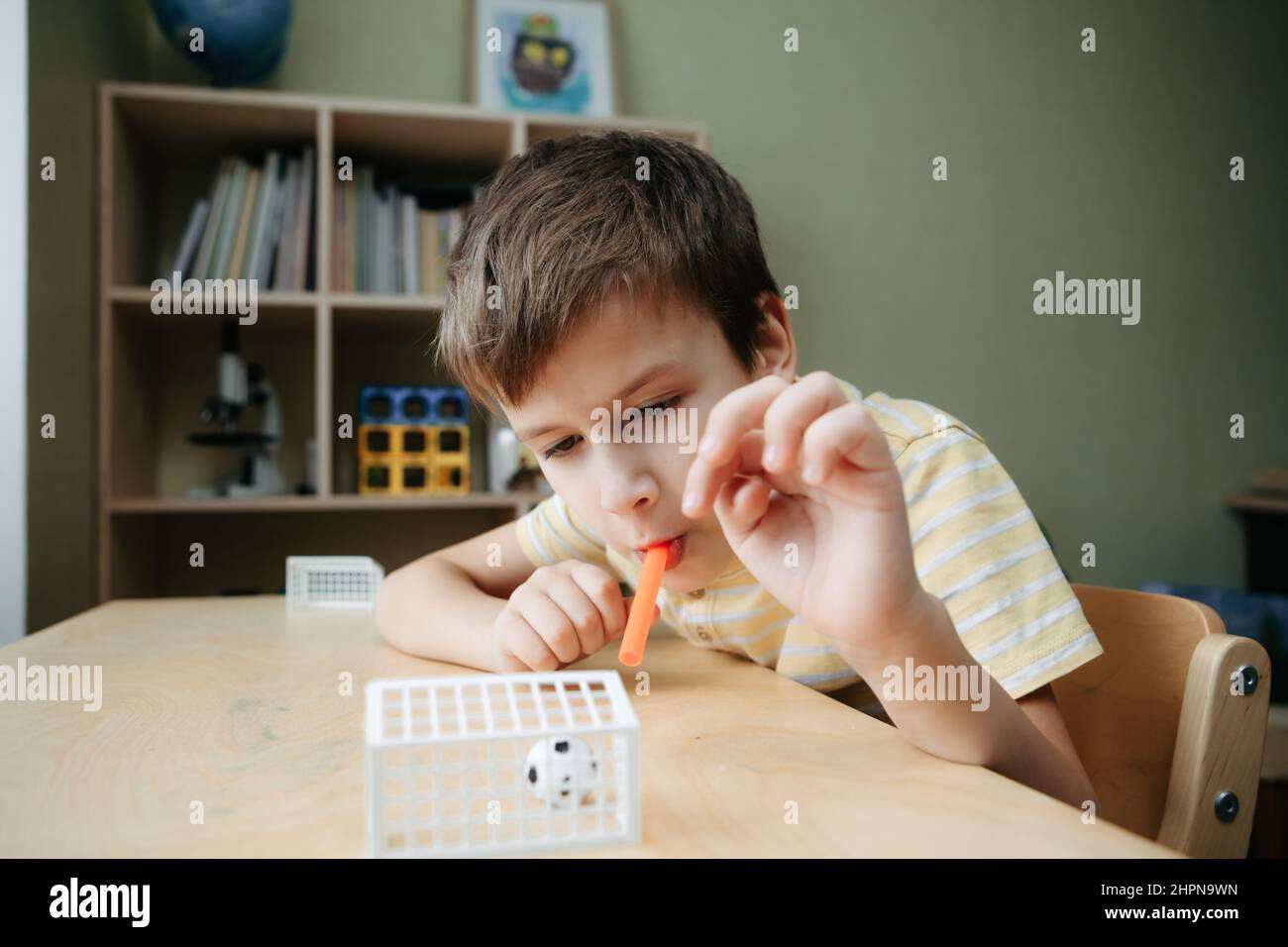 The child plays table football on the desk. Stock Photo