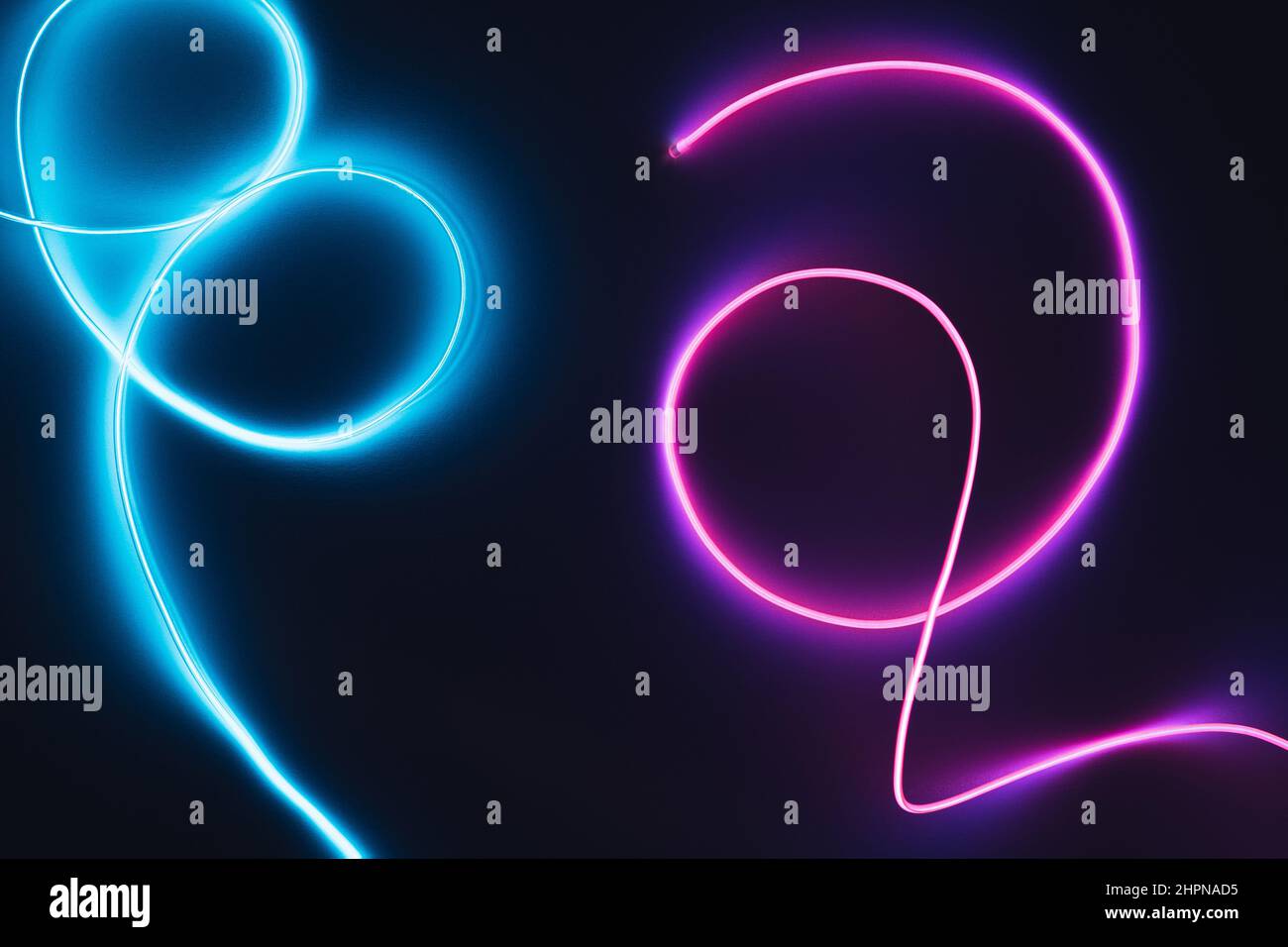 Neon blue and pink led lines on a dark night background. Cyberpunk futuristic backdrop. Stock Photo